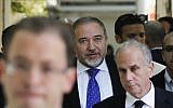 Former foreign minister Avigdor Liberman, center, walks toward a courtroom at the Magistrate's Court in Jerusalem, Wednesday, November 6, 2013 (photo credit: AP/Ronen Zvulun, Pool)