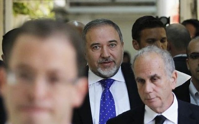 Former foreign minister Avigdor Liberman, center, walks toward a courtroom at the Magistrate's Court in Jerusalem, Wednesday, November 6, 2013 (photo credit: AP/Ronen Zvulun, Pool) Former foreign minister Avigdor Liberman, center, walks toward a courtroom at the Magistrate's Court in Jerusalem, Wednesday, November 6, 2013 (photo credit: AP/Ronen Zvulun, Pool)