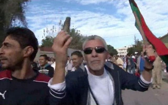 A protester holds up spent ammunition in Tripoli, Libya after militiamen attacked peaceful protesters demanding the disbanding of the country's rampant armed groups on Friday, Nov. 15, 2013. (photo credit: AP via AP video) A protester holds up spent ammunition in Tripoli, Libya after militiamen attacked peaceful protesters demanding the disbanding of the country's rampant armed groups on Friday, Nov. 15, 2013. (photo credit: AP via AP video)