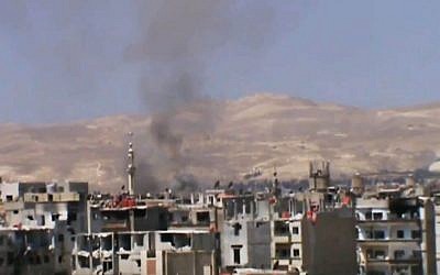 Black smoke billows in the air from heavy shelling near Damascus, Syria, on Monday, November 4, 2013 (photo credit: AP/Shaam News Network via AP video)