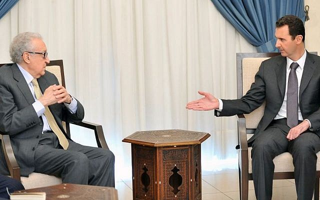 Syrian President Bashar Assad (right), speaks with UN-Arab League envoy for Syria, Lakhdar Brahimi, in Damascus, Syria, on Wednesday, October 30, 2013. (photo credit: AP/SANA) Syrian President Bashar Assad (right), speaks with UN-Arab League envoy for Syria, Lakhdar Brahimi, in Damascus, Syria, on Wednesday, October 30, 2013. (photo credit: AP/SANA)