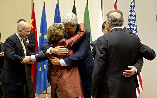 US Secretary of State John Kerry, center, embraces EU foreign policy chief Catherine Ashton, during a ceremony at the United Nations after an agreement was reached on Iran's nuclear program, in Geneva, Switzerland, Sunday, Nov. 24, 2013. (Photo credit: AP Photo/Keystone, Martial Trezzini) US Secretary of State John Kerry, center, embraces EU foreign policy chief Catherine Ashton, during a ceremony at the United Nations after an agreement was reached on Iran's nuclear program, in Geneva, Switzerland, Sunday, Nov. 24, 2013. (Photo credit: AP Photo/Keystone, Martial Trezzini)