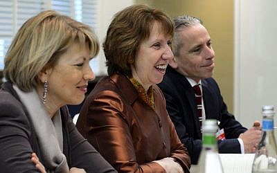 EU foreign policy chief Catherine Ashton, center, next to members of her delegation attends talks over Iran's nuclear program in Geneva on Friday Nov. 22, 2013. (photo credit: AP PhotoFabrice Coffrini,Pool)