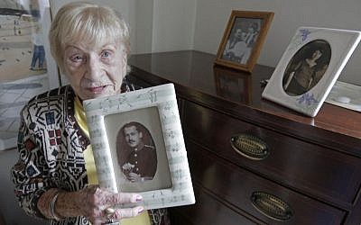 Holocaust survivor Edith Stern, 92, holds a picture of her father at the retirement community called Selfhelp Home, on the North Side of Chicago. (photo credit: AP Photo/M. Spencer Green, File)