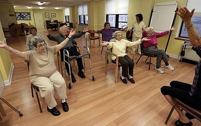 Holocaust survivor, Margie Oppenheimer, 89, left, participates in a yoga class with others at the retirement community called Selfhelp Home, on the North Side of Chicago. (photo credit: AP Photo/M. Spencer Green)
