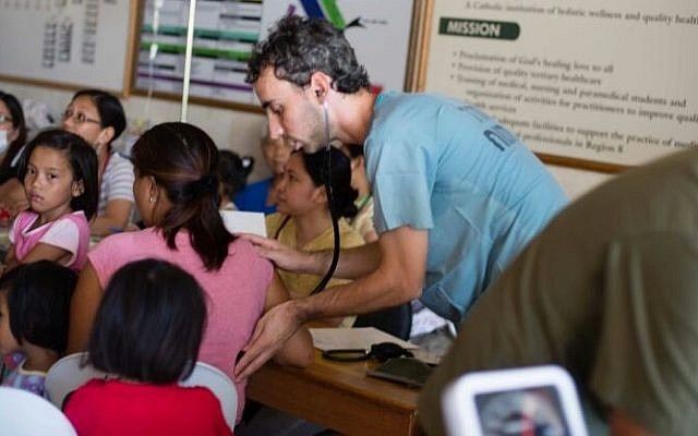 Members of IsraAID's medical team treat those affected by the typhoon. (Photo credit: IsraAID/Nufar Tagar)