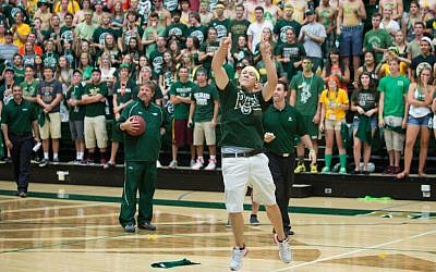 Colorado State University freshman Andrew Schneeweis sinks a half-court shot at a pep rally to win a year’s free tuition. (photo credit:John Eisele/CSU Photography/JTA)