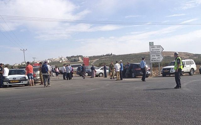 Some two dozen Gush Etzion residents held a demonstration Friday November 8, 2013 to demand better protection in the settlements. The protest came in response to a firebomb attack on a couple's car earlier in the day. The two managed to escape, sustaining light injuries. (Photo credit: Elie Leshem/Times of Israel) Some two dozen Gush Etzion residents held a demonstration Friday November 8, 2013 to demand better protection in the settlements. The protest came in response to a firebomb attack on a couple's car earlier in the day. The two managed to escape, sustaining light injuries. (Photo credit: Elie Leshem/Times of Israel)