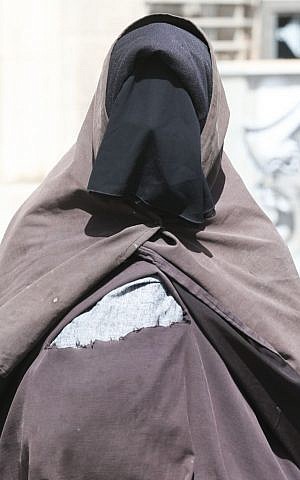 An ultra-orthodox woman covered from head to toe walks in a street in central Jerusalem on May 29, 2013. (Illustrative photo credit: Nati Shohat/Flash90)