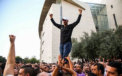 Arab Israelis protest outside the Haifa District Court during the sentencing of seven Israeli Arab men convicted of attempted manslaughter in the killing of Jewish terrorist Eden Natan Zada, Thursday, November 28, 2013 (photo credit: Avishag Shaar Yeshuv/Flash 90)