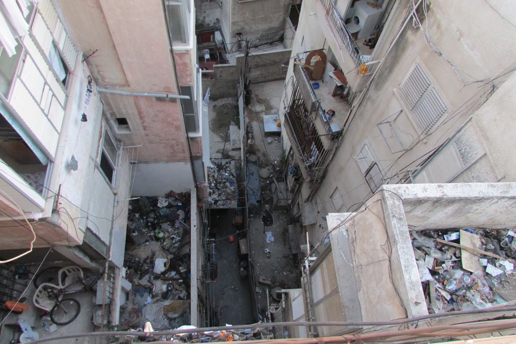 Looking down from the roof of Menashe's building, the garbage and filth is obvious. (photo credit: Debra Kamin) Looking down from the roof of Menashe's building, the garbage and filth is obvious. (photo credit: Debra Kamin)