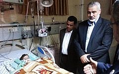 Hamas Prime Minister Ismail Haniyeh visits his granddaughter Aamal at a hospital in Gaza (photo credit: Facebook image)