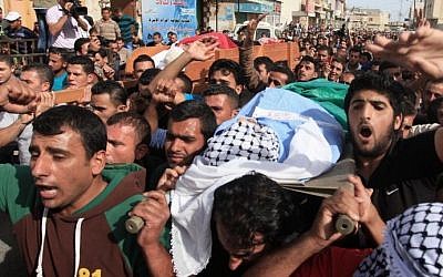 Mourners attend the funeral of Palestinian militants Khaled al-Najjar and Mussa Fanasheh on November 27, 2013 in the West Bank village of Yatta, one day after they were shot dead, along with another Palestinian activist. (photo credit: Issam Rimawi/FLASH90)