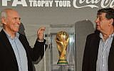 Former Israeli soccer player Mordechai Spiegler (L) with Itzhak Shum stand beside the FIFA World Cup, in Tel Aviv, Israel, November 10, 2013 (photo credit: Yossi Zeliger/Flash90)