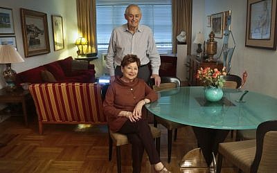 Victims of Bernie Madoff's massive Ponzi scheme, Morton Chalek, 91, standing, a WWII vet, and his friend Fran Reiss, 79, a retired educator, pose in the apartment they share, on Thursday, Dec. 5, 2013 in New York. (photo credit: AP Photo/Bebeto Matthews)