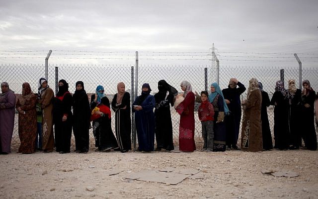 File photo: Syrian refugee women stand in line to receive their family's share of winter aid kits at the Zaatari refugee camp, near the Syrian border. (photo credit: AP/Mohammad Hannon) File photo: Syrian refugee women stand in line to receive their family's share of winter aid kits at the Zaatari refugee camp, near the Syrian border. (photo credit: AP/Mohammad Hannon)