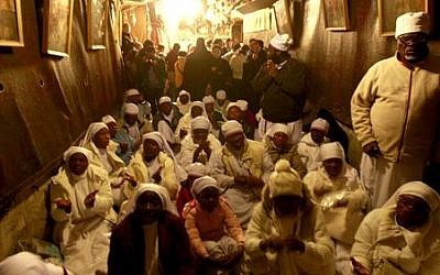 Christian worshipers from Nigeria pray at the Church of Nativity, traditionally believed by Christians to be the birthplace of Jesus Christ, in the West Bank town of Bethlehem on Christmas Eve, Tuesday, Dec. 24, 2013 (photo credit: AP/Majdi Mohammed)
