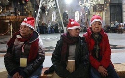 Christian worshipers visit the Church of Nativity, traditionally believed by Christians to be the birthplace of Jesus Christ, in the West Bank town of Bethlehem on Christmas Eve, Tuesday, Dec. 24, 2013. (photo credit: AP/Majdi Mohammed)