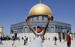 Illustrative of a masked Palestinian youth near the Dome of the Rock during clashes with Israeli riot police following Friday prayers at Jerusalem's al-Aqsa mosque compound on September 6, 2013. (photo credit: Sliman Khader/Flash90)