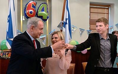 Prime Minister Benjamin Netanyahu -- seen with his wife, Sara, and their son, Yair --
celebrates his 64th birthday, at the PMO in Jerusalem, October 20, 2013 (Kobi Gideon GPO/FLASH90)