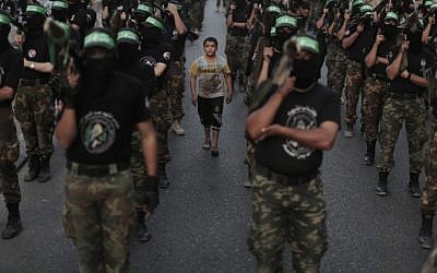 Members of the Izz ad-Din al-Qassam Brigades, Hamas's armed wing, stage an anti-Israel parade as part of the celebrations marking the first anniversary of Operation Pillar of Defense, on November 14, 2013. (Photo credit: Wissam Nassar/Flash90)