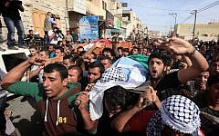Mourners attend the funeral of Palestinian militants Khaled al-Najjar and Mussa Fanasheh on November 27, 2013 in the West Bank village of Yatta, one day after they were shot dead, along with another Palestinian activist (photo credit: Issam Rimawi/Flash90)