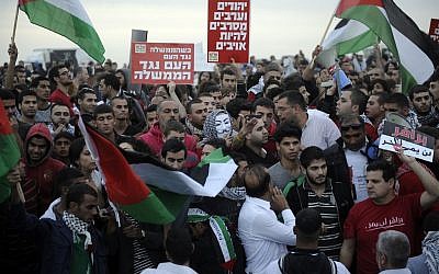 Police and protesters clash at a rally where around 1,200 demonstrators gathered in the southern Israeli town of Hura during a protest against the government's plan to resettle some 30,000 Bedouin residents of the Negev desert Saturday. (photo credit: David Buimovitch/Flash90)