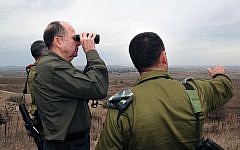 Defense Minister Moshe Ya'alon looks into Syrian territory from the Golan Heights on December 3, 2013. (Photo credit: Ariel Hermoni/Ministry of Defense/Flash 90)