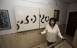 Peggy Cidor standing next to graffiti outside her home Thursday. (photo credit: Yonatan Sindel/Flash90)