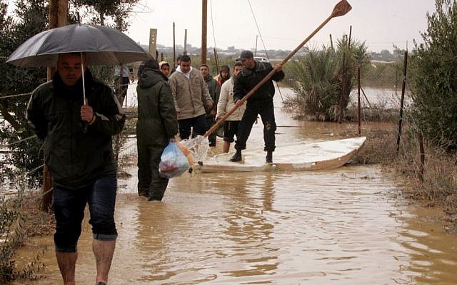 A member of the Palestinian civil defense forces paddles a boat as he floats across flood waters in Khan Yunis, Gaza, following storms (Photo credit: Abed Rahim Khatib / Flash 90) A member of the Palestinian civil defense forces paddles a boat as he floats across flood waters in Khan Yunis, Gaza, following storms (Photo credit: Abed Rahim Khatib / Flash 90)