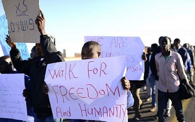 Sudanese refugees march toward Jerusalem in protest of the new Holot detention center for illegal migrants on Monday, December 16, 2013. (photo credit: Tomer Neuberg/Flash90) Sudanese refugees march toward Jerusalem in protest of the new Holot detention center for illegal migrants on Monday, December 16, 2013. (photo credit: Tomer Neuberg/Flash90)