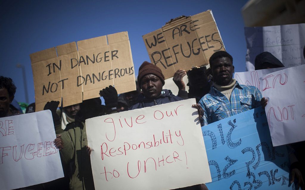 Sudanese refugees demonstrate in front of the Knesset in protest of the new "Holot" detention camp for illegal migrants, on Monday, December 17, 2013. (photo credit: Yonatan Sindel/Flash90) Sudanese refugees demonstrate in front of the Knesset in protest of the new "Holot" detention camp for illegal migrants, on Monday, December 17, 2013. (photo credit: Yonatan Sindel/Flash90)