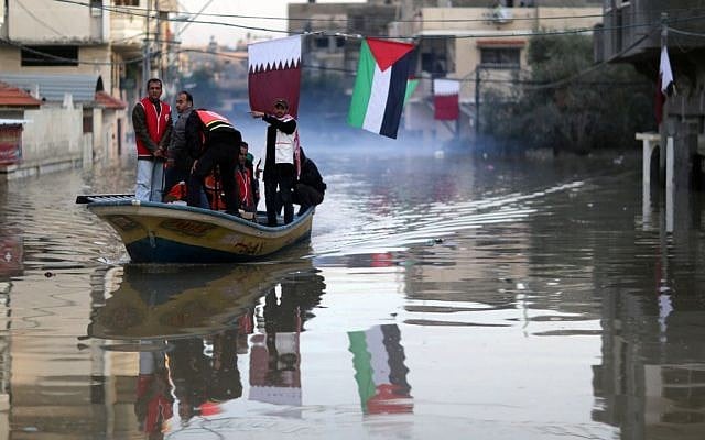 Palestinians take a boat through flooded streets in Gaza City, December 17, 2013 (photo credit: Wissam Nassar/Flash90) Palestinians take a boat through flooded streets in Gaza City, December 17, 2013 (photo credit: Wissam Nassar/Flash90)