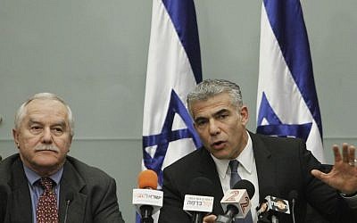 Finance Minister Yair Lapid (R) and Minister of Agriculture Yair Shamir attend a press conference announcing a controlled reduction of the price of soft white cheese and whipping cream, December 30, 2013. (photo credit: Miriam Alster/Flash90)