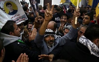 Illustrative: Palestinians celebrate at the welcome reception for released Palestinian prisoners, at the Muqata'a in Ramallah, in the early hours of Tuesday, December 31, 2013. (photo credit: Hadas Parush/Flash90)
