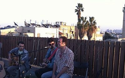 Performing at the Friday on the rooftop series at Ami Yares's Jaffa apartment. From right: Ami Yares, Avi Salloway, and Jason Reich (photo credit: Michal Shmulovich)