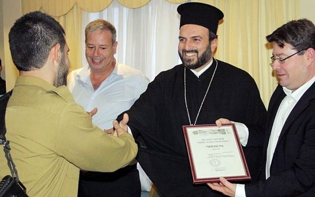 A Christian Arab soldier receiving a certificate of appreciation from Greek Orthodox priest Gabriel Naddaf during a 2013 event in Nazareth (photo credit: courtesy IDF Spokesperson's Unit) A Christian Arab soldier receiving a certificate of appreciation from Greek Orthodox priest Gabriel Naddaf during a 2013 event in Nazareth (photo credit: courtesy IDF Spokesperson's Unit)