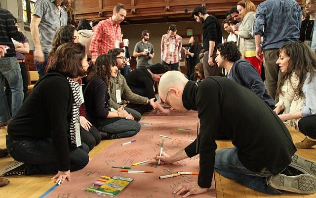 At the March Asylum Arts workshop, participants create a community timeline. (photo credit: Shulamit Siedler-Feller) At the March Asylum Arts workshop, participants create a community timeline. (photo credit: Shulamit Siedler-Feller)