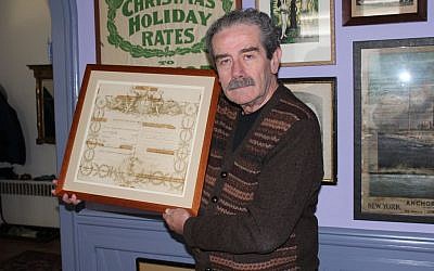 Major League Baseball’s official historian, John Thorn, pictured holding a royal decree knighting his great-grandfather, says the past enhances the present in sports as well as family matters. (photo credit: Hillel Kuttler/JTA)