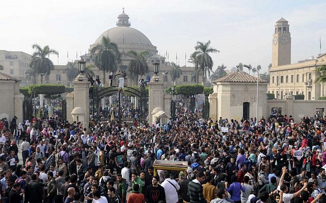 Student protesters gather outside the main gate of Cairo University, Cairo, Egypt Sunday, Dec. 1, 2013 before marching to Tahrir square. (photo credit: AP/Mohammed Asad) Student protesters gather outside the main gate of Cairo University, Cairo, Egypt Sunday, Dec. 1, 2013 before marching to Tahrir square. (photo credit: AP/Mohammed Asad)