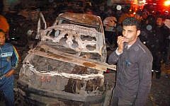 Egyptians gather after a powerful explosion believed to be caused by a car bomb rocked a police headquarters in the Nile Delta city of Mansoura, 110 kilometers (70 miles) north of Cairo on Tuesday, December 24. 2013. (photo credit: AP Photo)