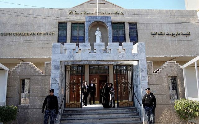 Iraqi police officers guard the entrance of St. Joseph's Chaldean Church before a Christmas mass in Baghdad, Iraq, Wednesday, Dec. 25, 2013. (photo credit: AP/Karim Kadim) Iraqi police officers guard the entrance of St. Joseph's Chaldean Church before a Christmas mass in Baghdad, Iraq, Wednesday, Dec. 25, 2013. (photo credit: AP/Karim Kadim)