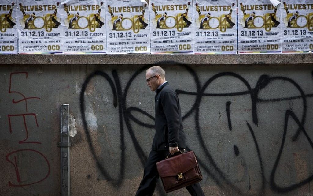 A man walks past posters advertising a New Year's Eve party in Tel Aviv, Israel, Monday, Dec. 30, 2013. In Israel, the somber, soul-searching and autumnal new year of the lunar Jewish calendar overshadows the Gregorian’s Jan. 1. (AP Photo/Oded Balilty) A man walks past posters advertising a New Year's Eve party in Tel Aviv, Israel, Monday, Dec. 30, 2013. In Israel, the somber, soul-searching and autumnal new year of the lunar Jewish calendar overshadows the Gregorian’s Jan. 1. (AP Photo/Oded Balilty)