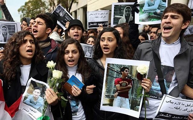 Lebanese students at the private Hariri High School, named after a prominent assassinated Sunni leader, chant slogans and hold photos of 16-year-old Mohammed Shaar, who was one of seven people killed in a car bomb that ripped through the upscale downtown district of Beirut, during a sit-in at the scene of the explosion in Beirut, Lebanon, Monday, Dec. 30, 2013. (AP Photo/Bilal Hussein) Lebanese students at the private Hariri High School, named after a prominent assassinated Sunni leader, chant slogans and hold photos of 16-year-old Mohammed Shaar, who was one of seven people killed in a car bomb that ripped through the upscale downtown district of Beirut, during a sit-in at the scene of the explosion in Beirut, Lebanon, Monday, Dec. 30, 2013. (AP Photo/Bilal Hussein)