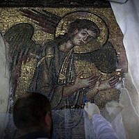 A restoration expert works on a mosaic inside the Church of the Nativity in the West Bank city of Bethlehem, on December 10, 2013. (photo credit: AP Photo/Nasser Nasser) A restoration expert works on a mosaic inside the Church of the Nativity in the West Bank city of Bethlehem, on December 10, 2013. (photo credit: AP Photo/Nasser Nasser)