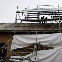 Restoration experts work on the roof of the Church of the Nativity in the West Bank city of Bethlehem, December 10, 2013 (photo credit: AP/Nasser Nasser) Restoration experts work on the roof of the Church of the Nativity in the West Bank city of Bethlehem, December 10, 2013 (photo credit: AP/Nasser Nasser)