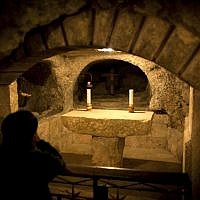 A tourist prays in the Grotto underneath the Church of the Nativity in the West Bank city of Bethlehem, on December 10, 2013. (photo credit: AP Photo/Nasser Nasser) A tourist prays in the Grotto underneath the Church of the Nativity in the West Bank city of Bethlehem, on December 10, 2013. (photo credit: AP Photo/Nasser Nasser)