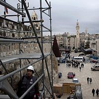 Tourists walk around the Church of the Nativity in the West Bank city of Bethlehem, on December 10, 2013. (photo credit: AP Photo/Nasser Nasser) Tourists walk around the Church of the Nativity in the West Bank city of Bethlehem, on December 10, 2013. (photo credit: AP Photo/Nasser Nasser)
