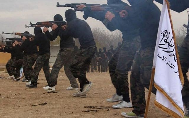 In this undated picture released on Friday, November 29, 2013, and posted on the Facebook page of a militant group, members of Ahrar al-Sham brigade, one of the Syrian rebels groups, exercise in a training camp at unknown place in Syria. (AP Photo)
