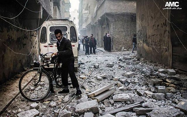 Residents inspect damaged buildings following government airstrikes in Aleppo, Syria, Dec. 23, 2013 (photo credit: AP/Aleppo Media Center AMC) Residents inspect damaged buildings following government airstrikes in Aleppo, Syria, Dec. 23, 2013 (photo credit: AP/Aleppo Media Center AMC)